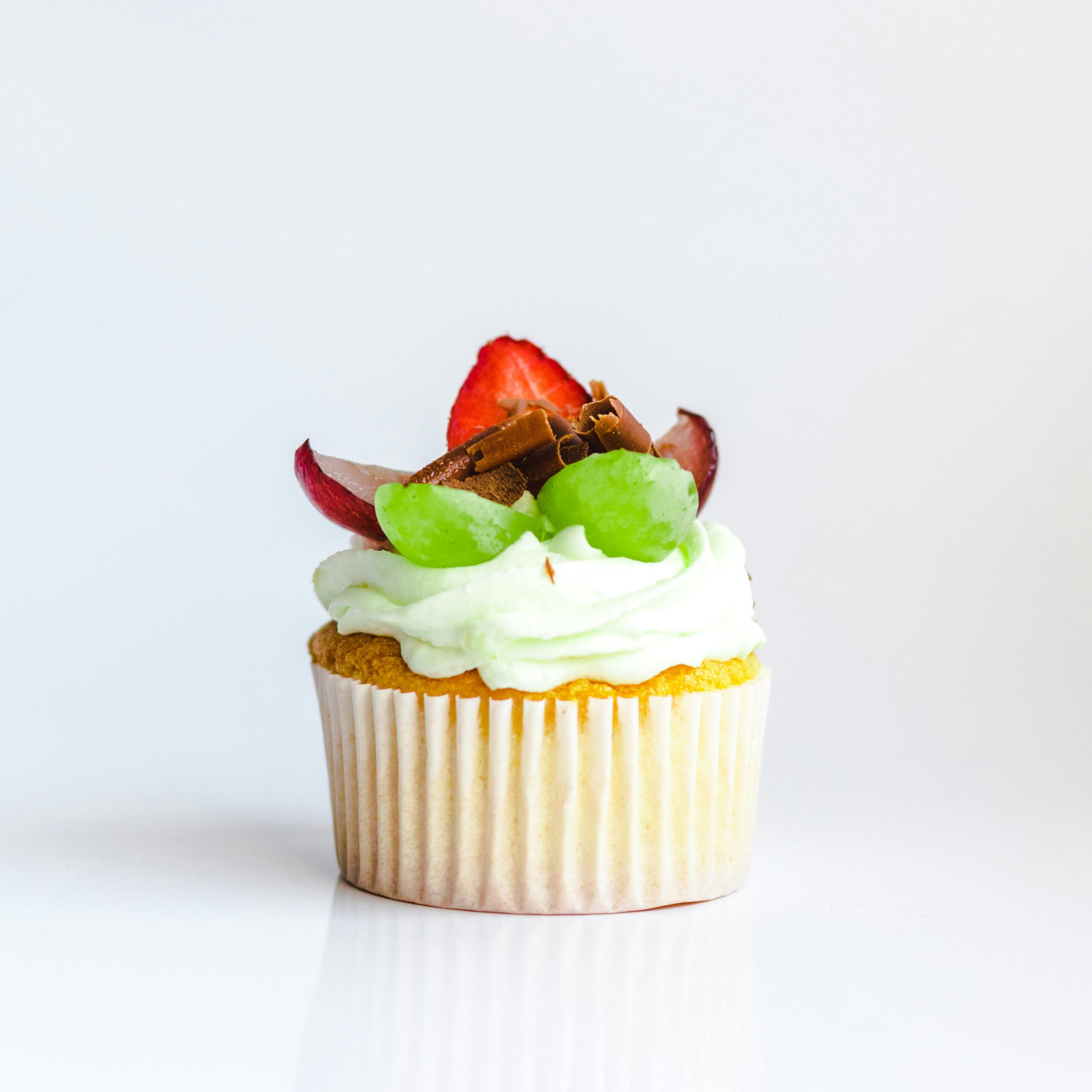 Cupcake with Whipped Cream and Fruits on Top