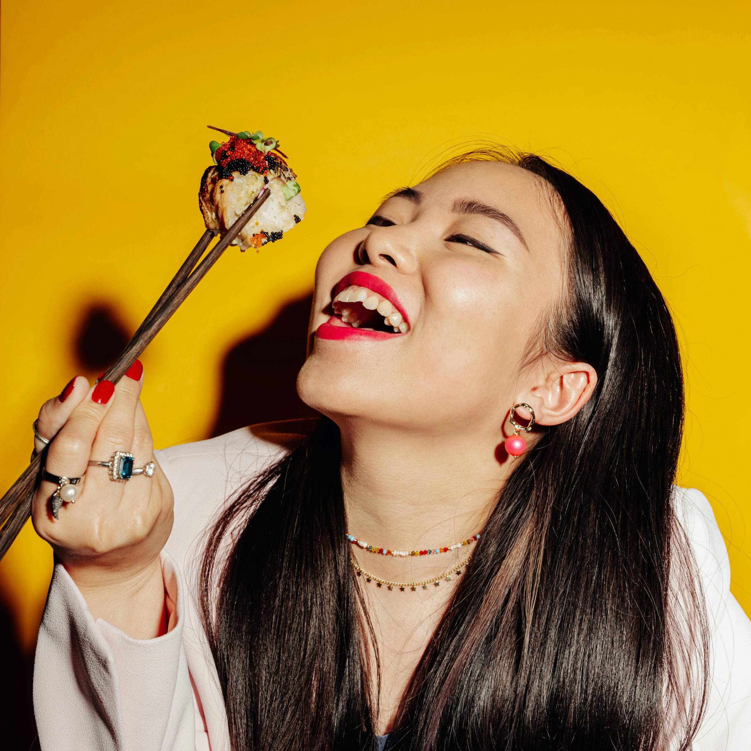 Woman with Open Mouth Holding Wooden Chopsticks with Maki