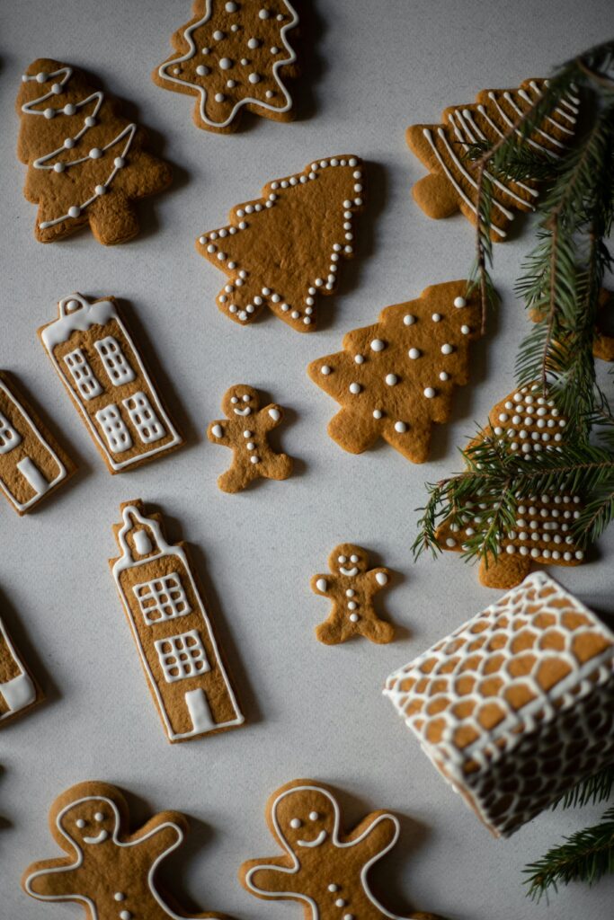 Flat lay of homemade gingerbread cookies with festive icing on a holiday theme.